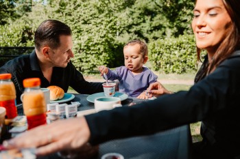 familie buiten tuin ontbijt